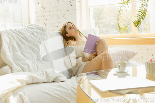 Image of Beautiful young woman relaxing at home, comfort and calm