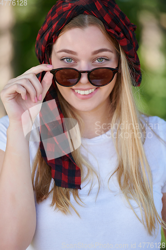 Image of portrait of beautiful, emotional, young woman in sunglasses.