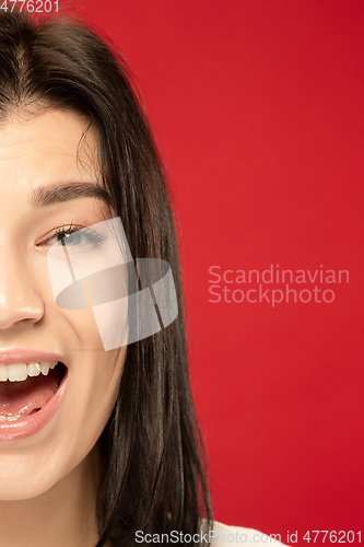 Image of Caucasian young woman\'s close up portrait on red background