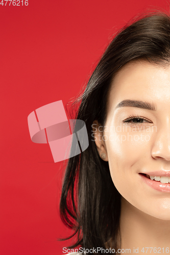 Image of Caucasian young woman\'s close up portrait on red background