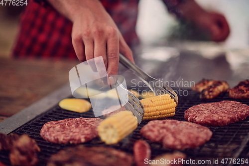 Image of man cooking tasty food for french dinner party