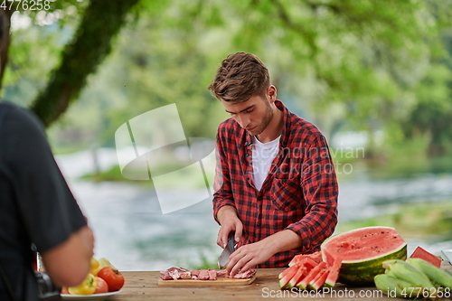 Image of man cooking tasty food for french dinner party