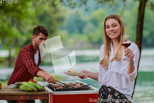 Image of friends having picnic french dinner party outdoor during summer holiday