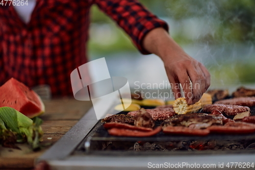 Image of man cooking tasty food for french dinner party