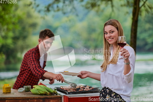 Image of friends having picnic french dinner party outdoor during summer holiday