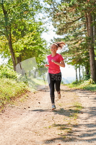 Image of woman enjoying in a healthy lifestyle while jogging