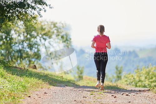 Image of woman enjoying in a healthy lifestyle while jogging