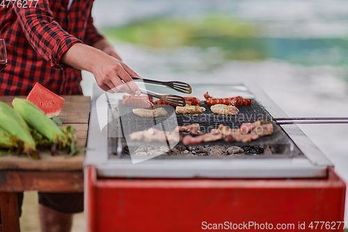 Image of man cooking tasty food for french dinner party