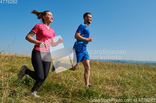 Image of couple jogging in a healthy lifestyle on a fresh mountain air