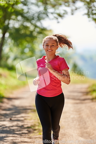 Image of woman enjoying in a healthy lifestyle while jogging