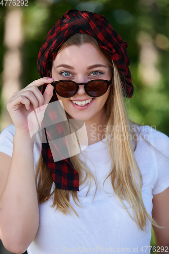 Image of portrait of beautiful, emotional, young woman in sunglasses.