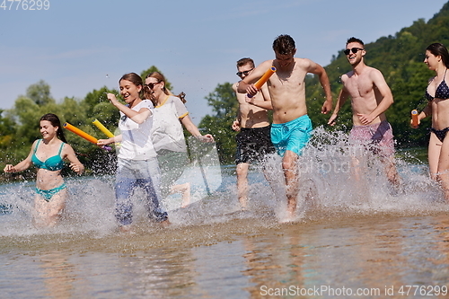 Image of group of happy friends having fun on river