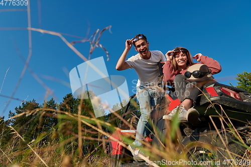 Image of couple enjoying beautiful sunny day while driving a off road buggy