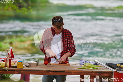 Image of man cooking tasty food for french dinner party