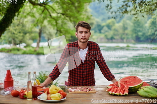 Image of man cooking tasty food for french dinner party