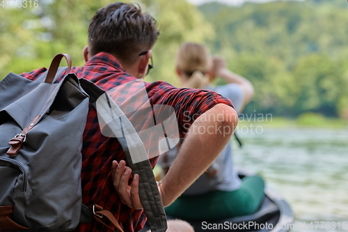 Image of friends are canoeing in a wild river