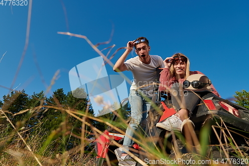 Image of couple enjoying beautiful sunny day while driving a off road buggy