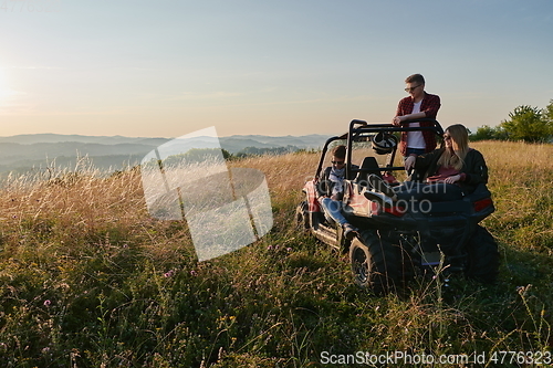 Image of group young happy people enjoying beautiful sunny day while driving a off road buggy car