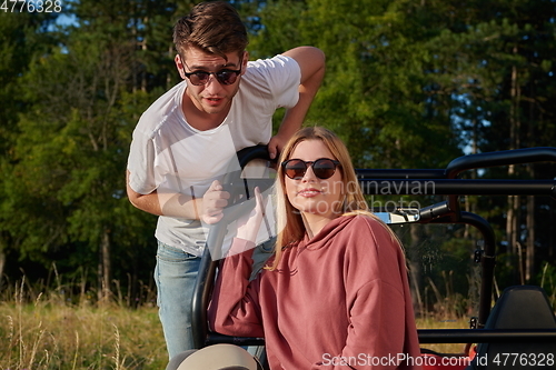 Image of couple enjoying beautiful sunny day while driving a off road buggy