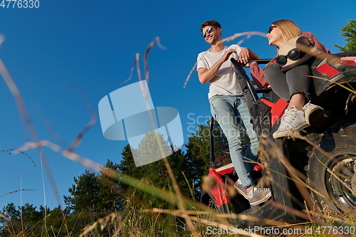 Image of couple enjoying beautiful sunny day while driving a off road buggy