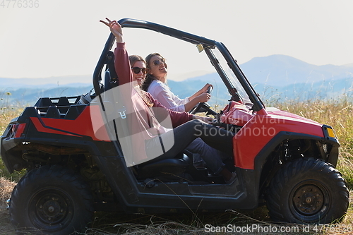 Image of girls enjoying a beautiful sunny day while driving an off-road car