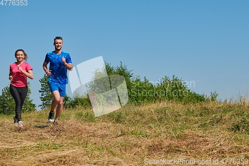 Image of couple jogging in a healthy lifestyle on a fresh mountain air