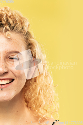 Image of Caucasian young woman\'s close up portrait on yellow background