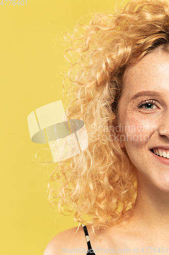 Image of Caucasian young woman\'s close up portrait on yellow background