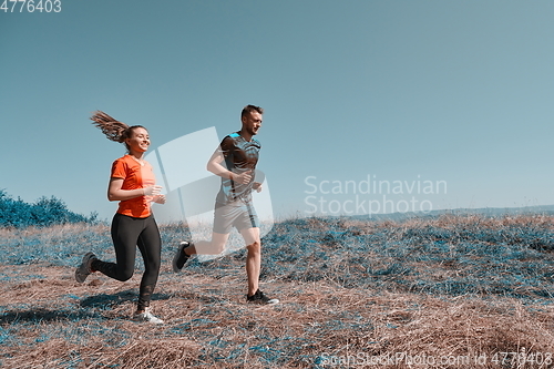 Image of couple jogging in a healthy lifestyle on a fresh mountain air