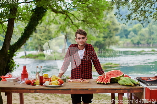 Image of man cooking tasty food for french dinner party