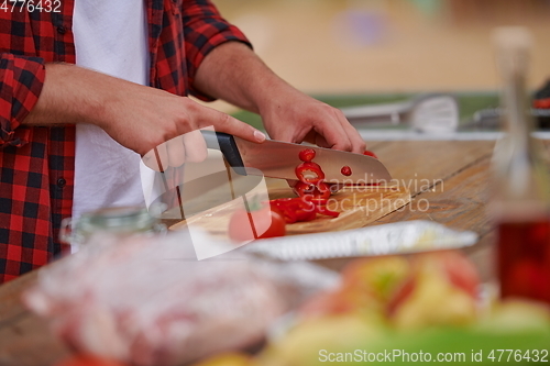 Image of man cooking tasty food for french dinner party