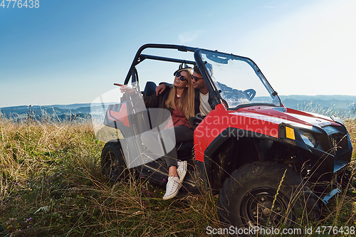 Image of cameraman recording a young couple enjoying a buggy car ride up a mountain