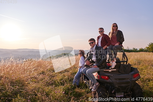 Image of group young happy people enjoying beautiful sunny day while driving a off road buggy car