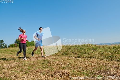 Image of couple jogging in a healthy lifestyle on a fresh mountain air