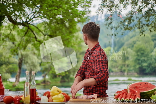 Image of man cooking tasty food for french dinner party