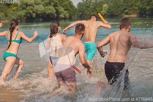 Image of group of happy friends having fun on river