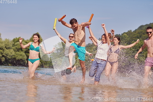 Image of group of happy friends having fun on river