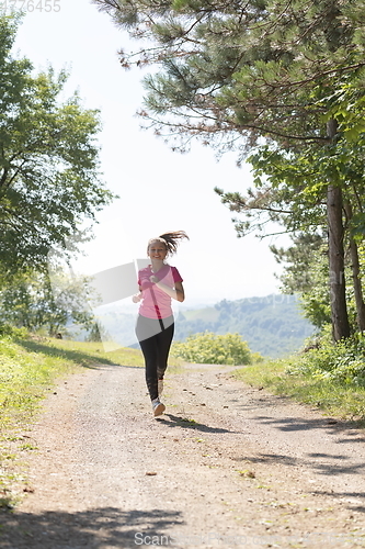 Image of woman enjoying in a healthy lifestyle while jogging