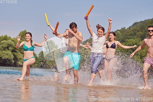 Image of group of happy friends having fun on river