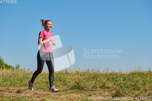 Image of woman enjoying in a healthy lifestyle while jogging