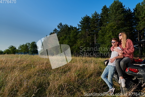 Image of couple enjoying beautiful sunny day while driving a off road buggy