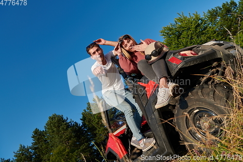 Image of couple enjoying beautiful sunny day while driving a off road buggy