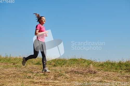 Image of woman enjoying in a healthy lifestyle while jogging