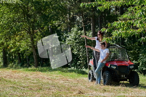 Image of couple enjoying beautiful sunny day while driving a off road buggy