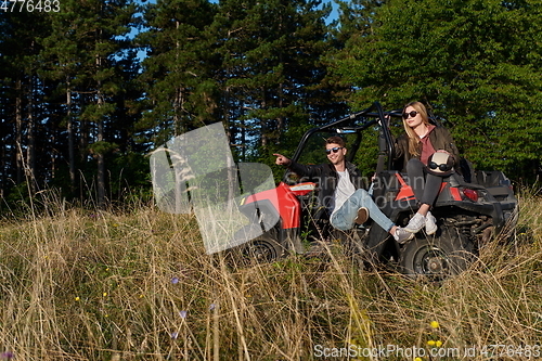 Image of couple enjoying beautiful sunny day while driving a off road buggy