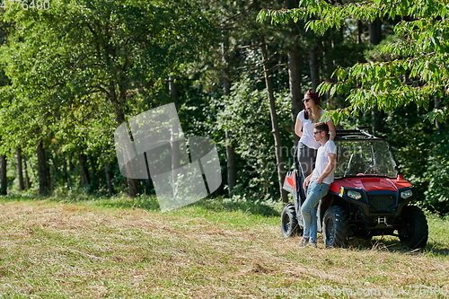 Image of couple enjoying beautiful sunny day while driving a off road buggy