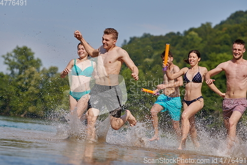 Image of group of happy friends having fun on river