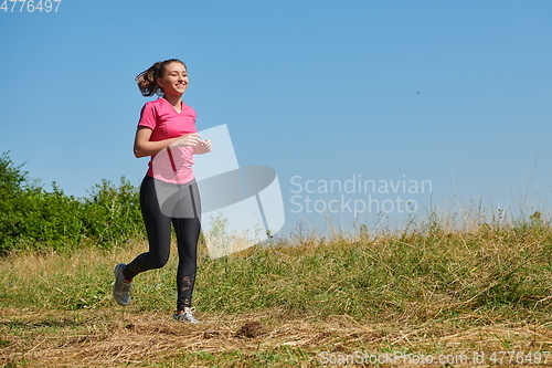 Image of woman enjoying in a healthy lifestyle while jogging