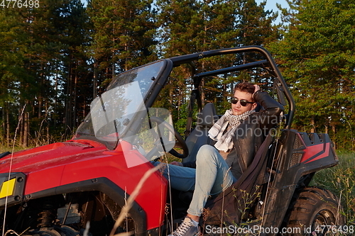 Image of man enjoying beautiful sunny day while driving a off road buggy car