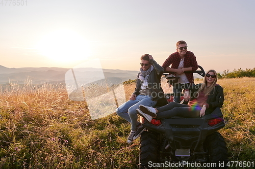 Image of group young happy people enjoying beautiful sunny day while driving a off road buggy car